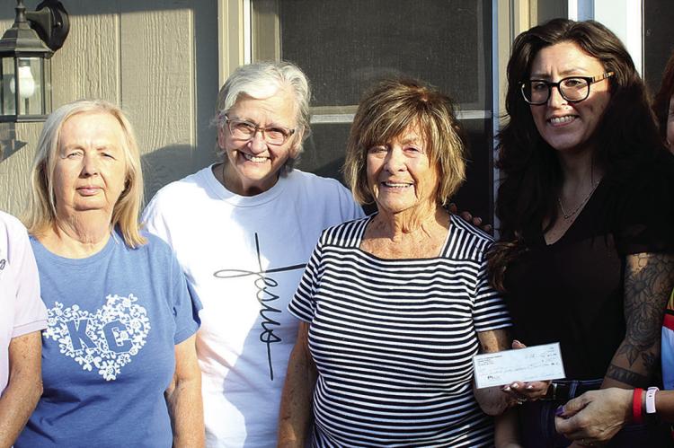 CARLA ELENZ (left) and Kathy Sowers (right) accept a donation from Faith Lutheran LWML members Tonya McBee, Donna Shane, Marian Berning and Cierra Miller. SHARON DONAT | Staff