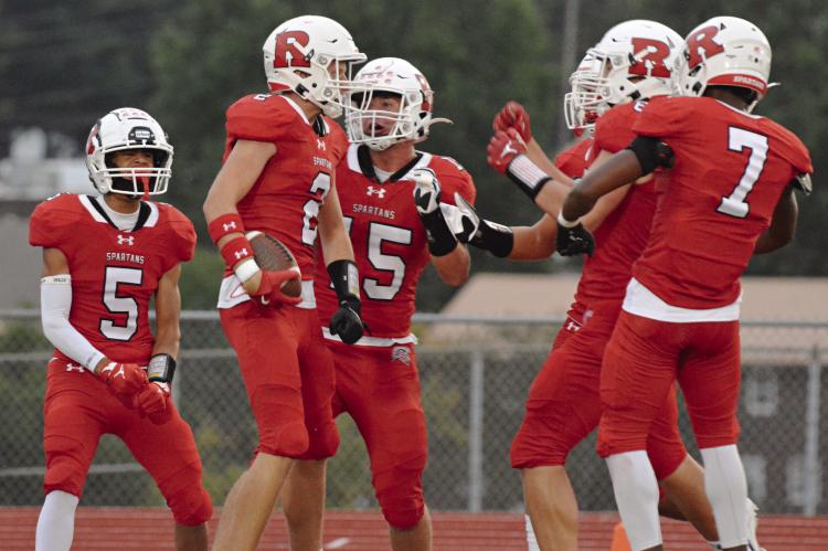 WITH SOME OF his teammates around him, Richmond senior Bryer Farnan (No. 2) celebrates after his first-half pick six against Marshall Sept. 13 at Spartan Stadium. SHAWN RONEY | Staff