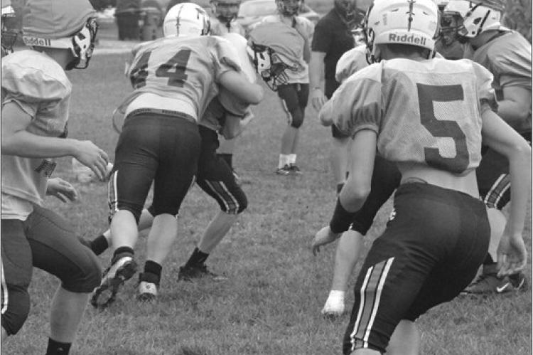 JADEN BARRETT (No. 44) wraps up for a tackle Monday on the practice field at Hardin-Central as the Norborne Hardin-Central varsity 8-man football co-op prepares to face Santa Fe Friday night in Alma. SHAWN RONEY | Staff