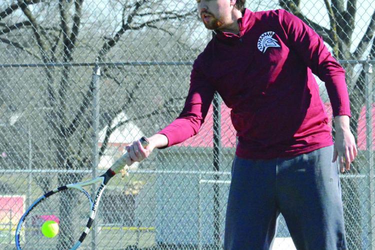 ZACHARY BALDAUF, Richmond’s new boys tennis coach, hits a forehand shot as he preps the Spartans for their spring schedule. SHAWN RONEY | Staff