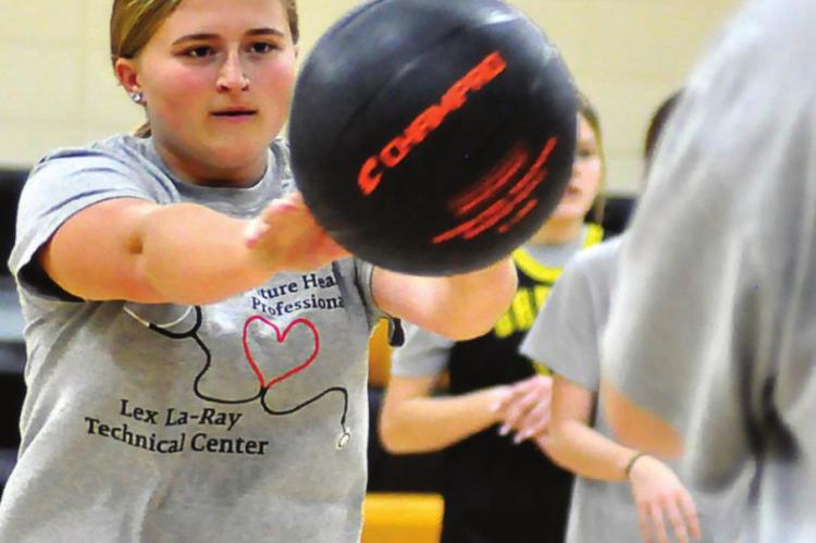 JUNIOR JANIE KILGORE practices passing in November in the Orrick High School gym. SHAWN RONEY | Staff