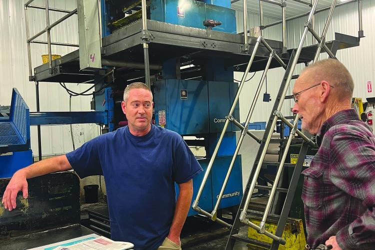 RICHMOND NEWS Pressman Danny Shull talks press work with attendee Edwin Sutton at the National Newspaper Week event last Thursday. SOPHIA BALES | Staff