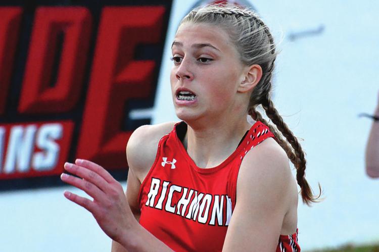 THE BLASTS of wind April 12 do not preclude a certain sports editor/ reporter/photographer from getting a closeup of Kaylee Pugh running the girls 200-meter dash, but they make recording a postrace interview challenging. At least there is no rain during the race or the interview. SHAWN RONEY | Staff