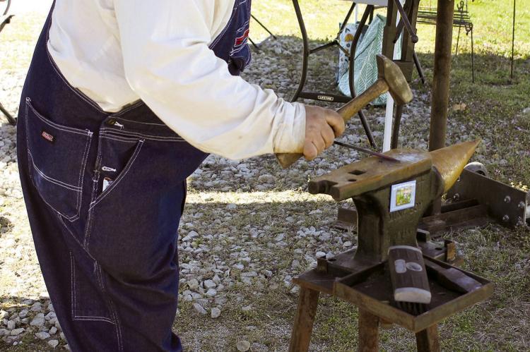 JEREMIE HOWELL OF H&amp;H Arts uses traditional blacksmithing techniques to make items at the homesteading Easter event. SOPHIA BALES | Staff