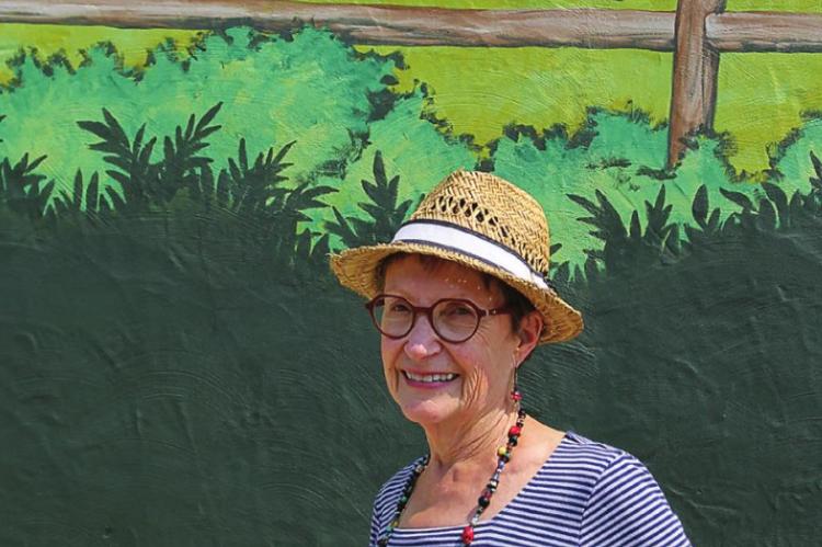 THE SKETCH artist for the mural, Patricia Pierce, stands in front of the completed mural. J.C. VENTIMIGLIA | Staff