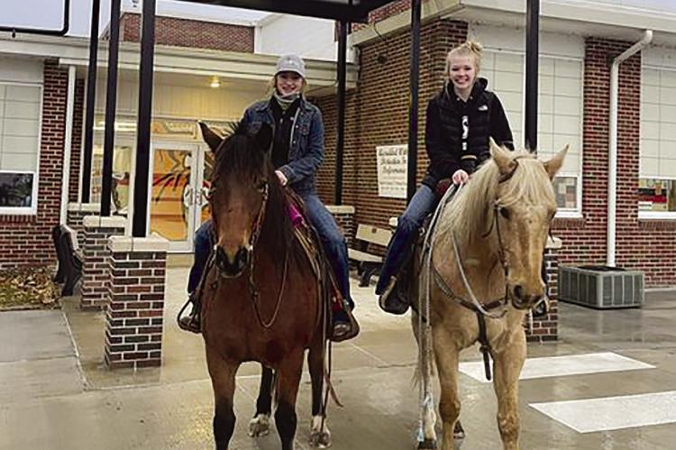Hardin-Central FFA students ride horses to school on Drive A Tractor Day