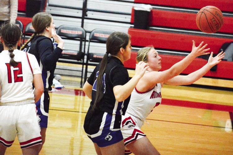 HER ARMS outstretched, junior Laney Moyer tries to keep the ball in play for Richmond Jan. 27 against Lone Jack in the Richmond Winter Classic. SHAWN RONEY | Staff