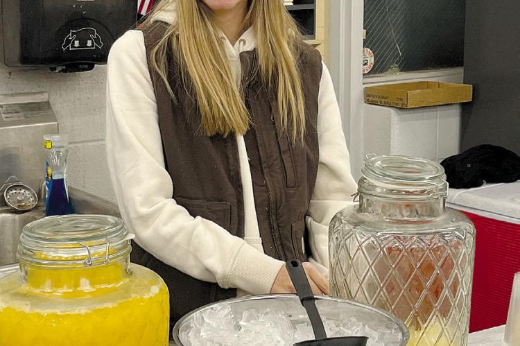 HIGH SCHOOL FFA student Emerson Rennison is excited to serve orange juice during the annual FFA breakfast, hosted by the Richmond High club. SOPHIA BALES | Staff