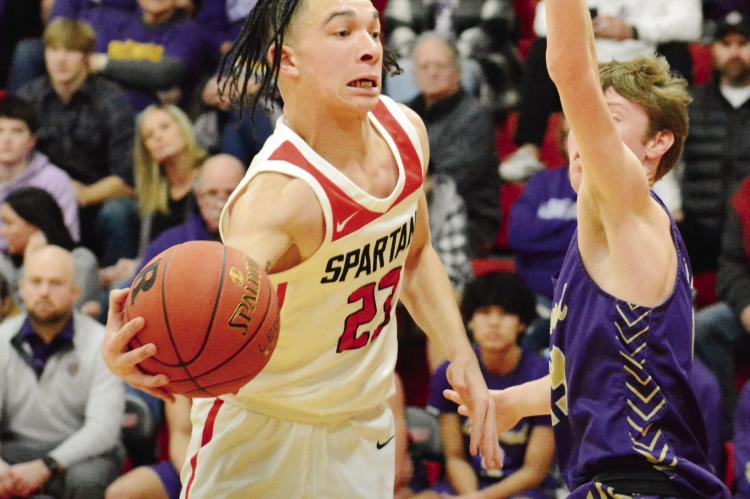 SENIOR DONIVIN WILLIAMS attempts a one-handed pass during the Spartans’ 79-62 win over Bishop LeBlond of St. Joseph in the Richmond Winter Classic title game Jan. 28 at Richmond High School. SHAWN RONEY | Staff