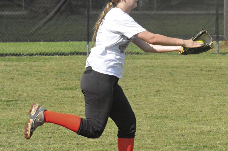 ZOEY POLK drills over catching fly balls during a recent practice at Norborne as she and her Norborne Hardin-Central teammates prep for the varsity season under Tommy Dunkin, their new skipper. SHAWN RONEY | Staff