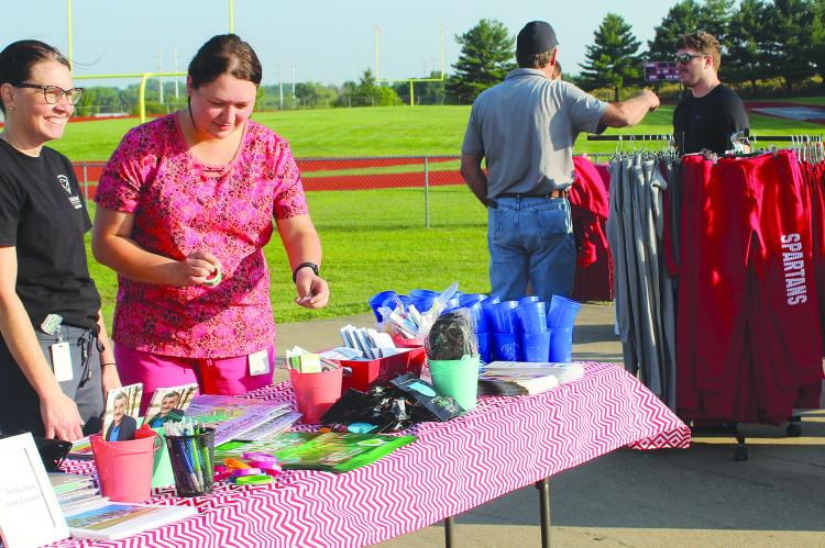 SHARON DONAT | Staff LPN SARAH KILPATRICK (left) and Public Health Educator Madilyn Stevenson prepare information from the Ray County Health Department.