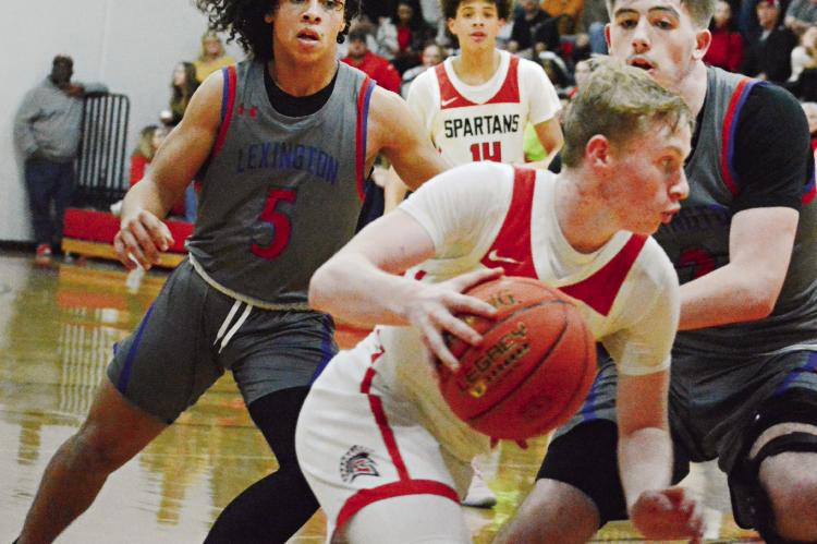 SOPHOMORE NOLAN QUICK dribbles to his right during the second half of Richmond’s Feb. 9 mat/ courtwarming meeting with visiting Lexington. SHAWN RONEY | Staff