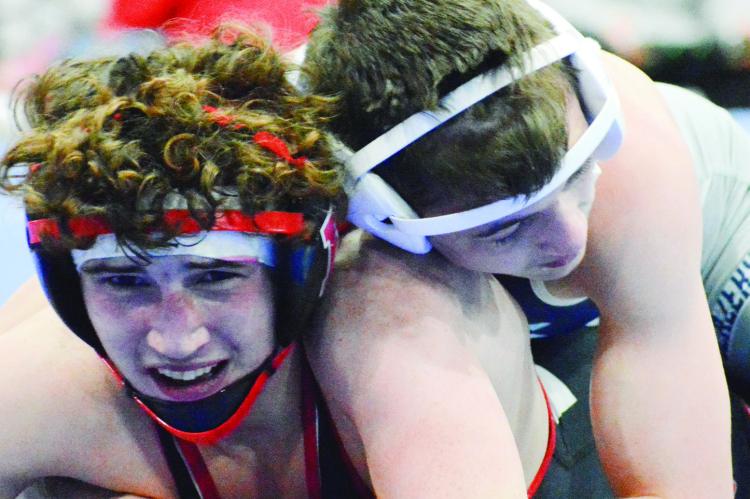 RICHMOND JUNIOR Declan Cockrum fights to get out from the bottom position during a Class 1 District 3 match Feb. 18 at Lafayette County of Higginsville. SHAWN RONEY | Staff