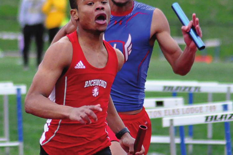 SENIOR ADRIAN CHURCH fights to keep Richmond’s lead Tuesday in the boys 400-meter relay at Lexington. SHAWN RONEY | Staff