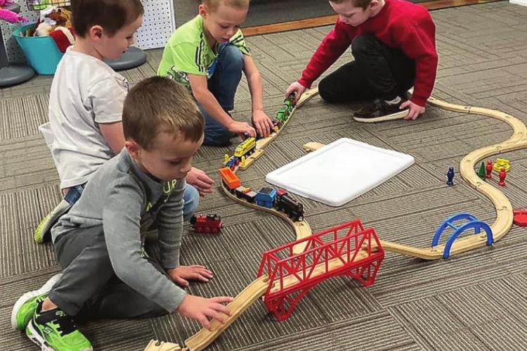 THESE BOYS design a pathway on which trains can travel. From front to back are Zander Marrant, Camden Breland-Armstrong, Drew Schutz and Stetson Hamilton.