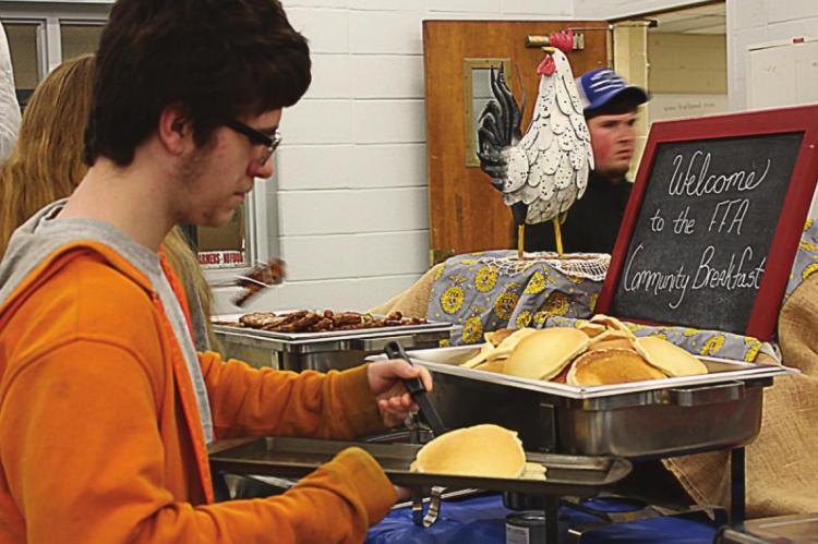 FRESHMAN FFA MEMBER Derek Day-Pinda refills pancakes to get ready to serve lots of Richmond FFA supporters at the annual FFA Community Breakfast.