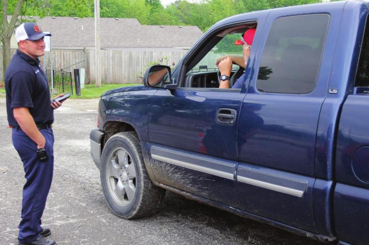 RICHMOND firefighter Cody Oliphant talks with Jerry McGraw while waiting for 15 minutes to pass after McGraw receives a COVID-19 shot on May 19 at the Ray County Fairgrounds.