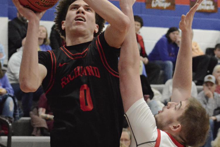 RICHMOND SENIOR Gabe Johnson attempts a shot in the post while contested by Colten Sawyer of Lexington. SHAWN RONEY | Staff