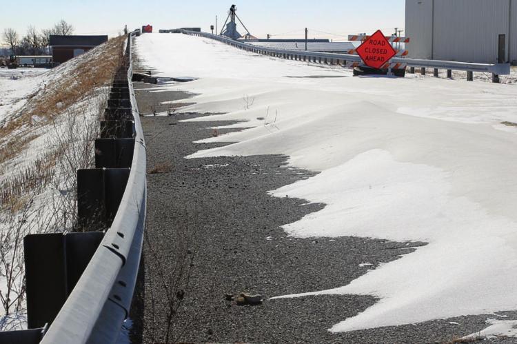 BLOWN SNOW, not traffic, crosses the closed old Missouri Highway 13 overpass in Henrietta. J.C. VENTIMIGLIA | Staff