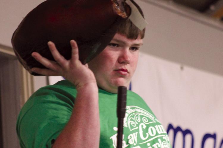 Jace McNelly awaits the highest bidder as he shows off his ham. SOPHIA BALES | Staff