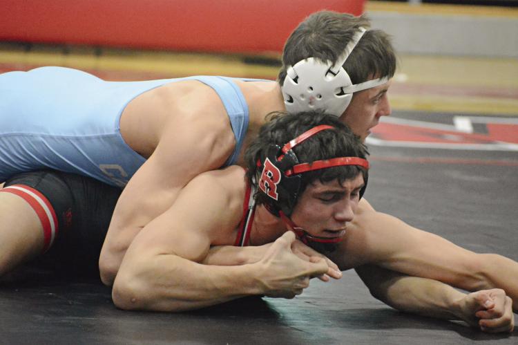 RICHMOND JUNIOR Madix Hutchings uses his right hand to try to break a hold by Ben Schroeder of Father Tolton Regional Catholic. For additional wrestling coverage, see page 16. SHAWN RONEY | Staff