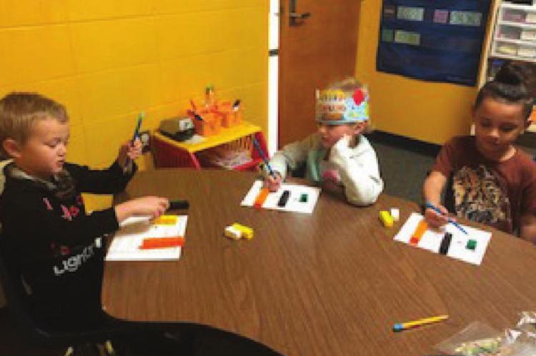 CORISSA HAMILTON’S children use connecting cubes to show different pairs of numbers that make connecting cubes. The students are Jayce Rodriguez, Barbara Floyd and Arthur Bivines.