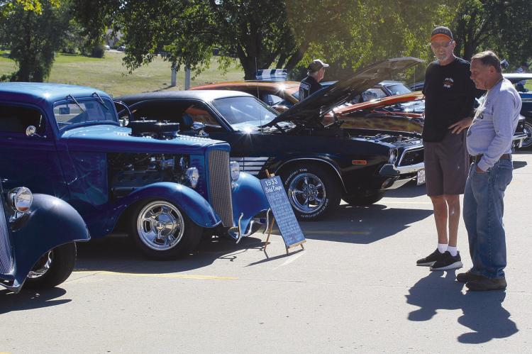 RON DELAY admires the 1933 Ford owned by Steve Dillon (left). SHARON DONAT | Staff
