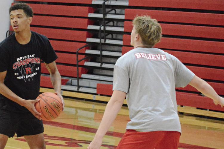 BRICE DOME (left) looks to pass during a Richmond off-season camp session. SHAWN RONEY | Staff