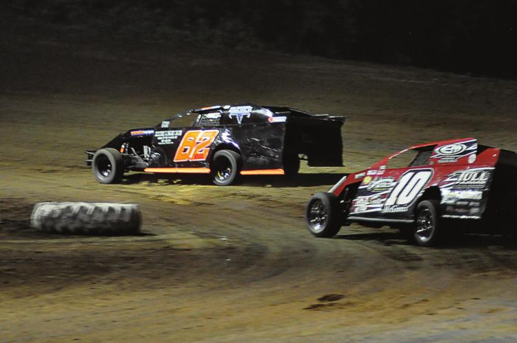 DRIVING THE NO. 82 car, Richmond’s David Wood barrels through a corner during a night race July 4 at Central Missouri Speedway near Warrensburg. SHAWN RONEY | Staff