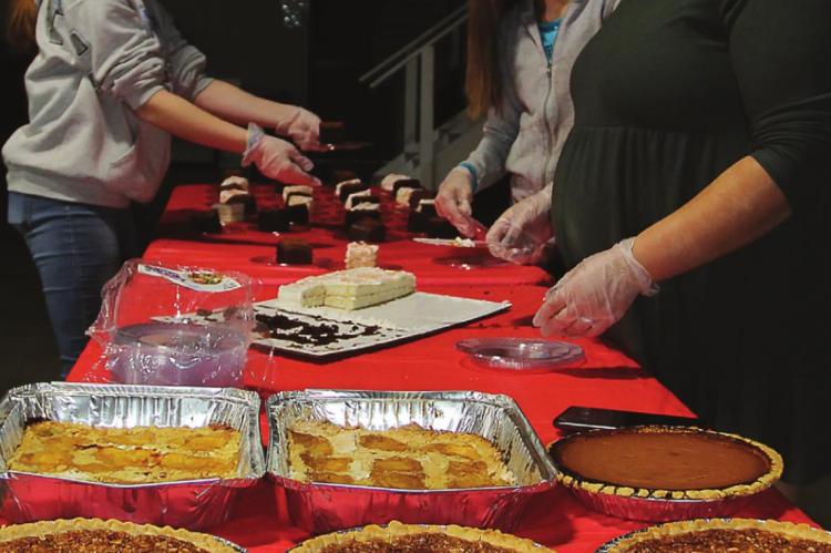 JUST DESSERTS are prepared for Thanksgiving dinner by, from left, Brooklynn Lowery, 14; Maryann Gingerich, 11; and Nina Barron, 24. J.C. VENTIMIGLIA | Staff