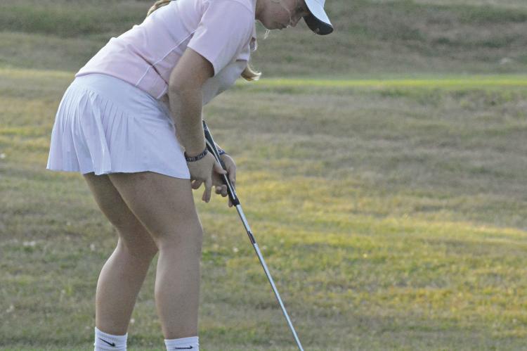 KAROLINE DOOLEY watches one of her putts roll into the hole during Richmond’s recent dual with Center at Shirkey Golf Course. SHAWN RONEY | Staff