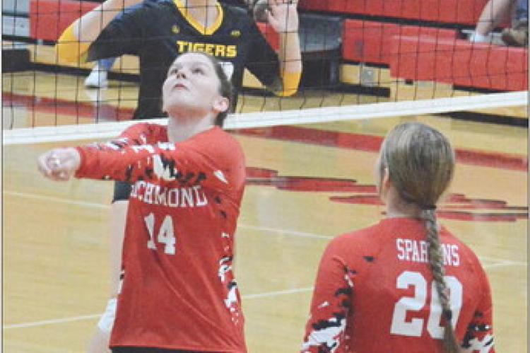 WITH FELLOW SPARTAN Avory Oliphant watching, Richmond sophomore Sydnee Burnett bumps the ball Sept. 14 during a best-of-five varsity volleyball match with visiting Wellington-Napoleon. SHAWN RONEY | Staff