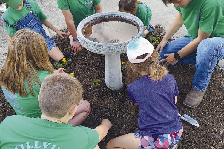 MILLEVILLE 4-H CLUB does a variety of projects, including planting flowers annually at Shirkey Nursing and Rehabilitation Center in Richmond. Submitted