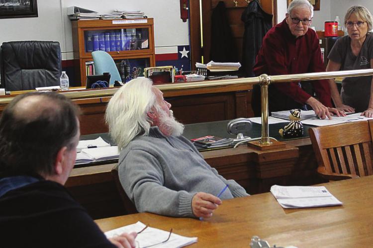 THE THREE COMMISSIONERS and the county clerk discuss budgeting and proposed 3% raises for all county employees, including officeholders. From left are Commissioners Gary Wilhite, Dave Powell and Bob King, and County Clerk Glenda Powell. J.C. VENTIMIGLIA | Staff