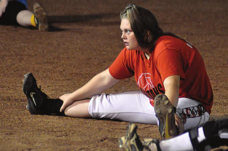 RICHMOND SENIOR Lexi Bokarae joins her teammates in stretching Monday morning on the infield at Southview Park as the Spartans continue their Midnight Madness tradition. SHAWN RONEY | Staff