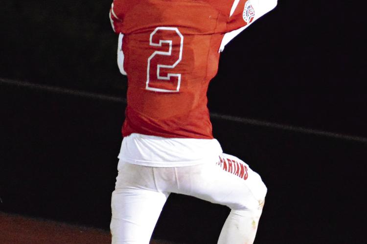 RICHMOND JUNIOR Bryer Farnan holds the football high as he leaps into the end zone for a thirdquarter touchdown Oct. 20 in The Bell Game against visiting Lexington. SHAWN RONEY | Staff