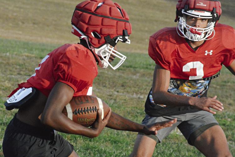 RICHMOND SENIOR Chris Webb (left) looks to get past teammate Brice Dome Monday on the high school practice field as the Spartans prepare to face archrival Lexington Friday in The Bell Game at Lexington. SHAWN RONEY | Staff