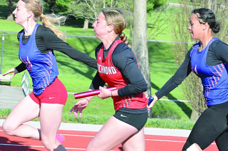 SHAWN RONEY | Staff RICHMOND JUNIOR SYDNEY APPLEBERRY bolts down the front straightaway and fights off a challenge from Lexington during the second leg of the girls 400-meter relay at the Bruce Finlayson Invitational April 21 at Carrollton.