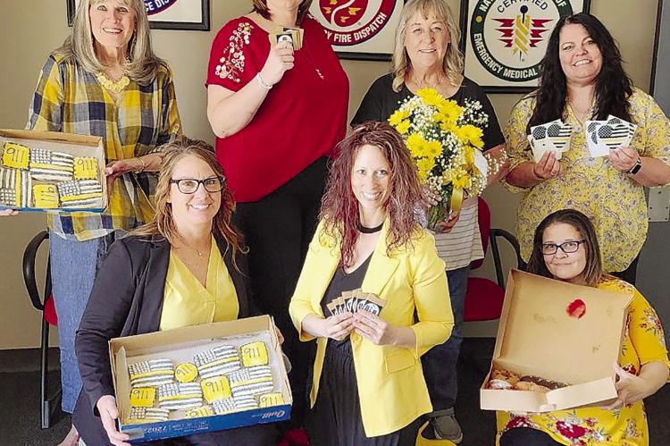 JANET LABARR (FROM LEFT), JENNIFER GRIMES, Heather Miller, Camille Johnston, Kim Davis, Tara Medlin and Melissa White celebrate National 911 Public Safety Telecommunications Week together. SOPHIA BALES | Staff