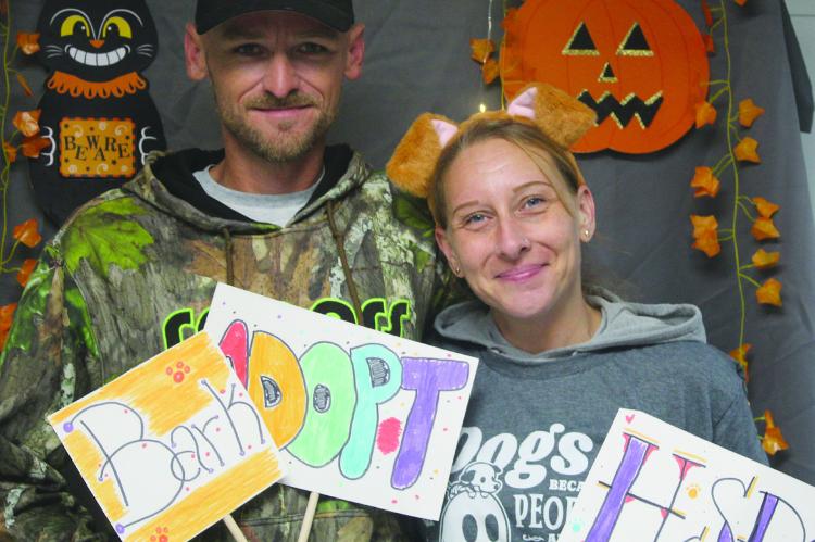 BRAD ADAMS (LEFT) AND Kelly Legate visit the Humane Society of Ray County’s new location at 104 North McCart Street for an open house where attendees toured the new shelter and met animals available for adoption. SHARON DONAT | Staff