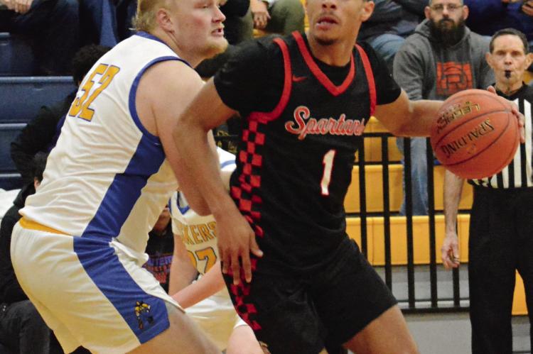 RICHMOND JUNIOR Brice Dome (right) attempts to drive past Lafayette County post player Lucas Burns during the Husker Classic. Additional tournament photos are on page 15. SHAWN RONEY | Staff
