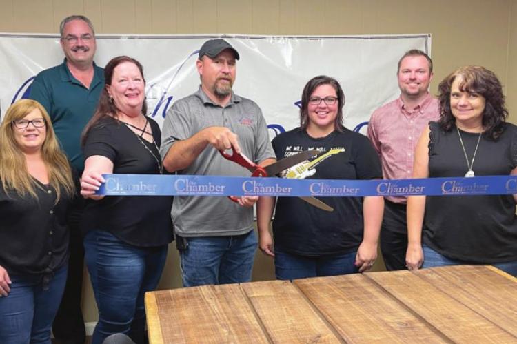 ATTENDING the Wisper Internet ribbon cutting July 15, from left, are Beth Smith; Brian Rice; Misti McKenzie; Damian Lemens, general manager; Mandi Tryon, marketing coordinator; James Gorham; and Carolyn Arney. EM RICE | Staff affiliate