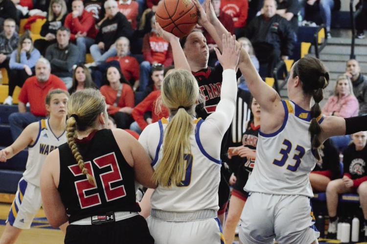 RICHMOND SENIOR Trinidy Fisk attempts a short jump shot over the outstretched left hand of St.Pius X senior Molly Cernich during Richmond’s 51-31 season-ending loss March 4 in Kansas City on the St. Pius campus. SHAWN RONEY | Staff
