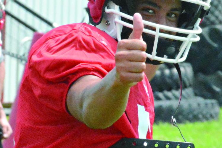 MALIKIAH THARP gives a thumbs up before running a pass route on the first day of Richmond’s prep football camp. SHAWN RONEY | Staff