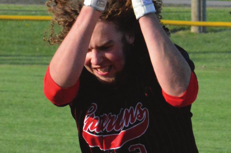 YIPEE! Richmond junior Jack Gogue flips his batting helmet to the dirt in jubilation Tuesday at Southview Park after providing the game-winning hit in Richmond’s 3-2 comeback victory over Lafayette County of Higginsville. SHAWN RONEY | Staff