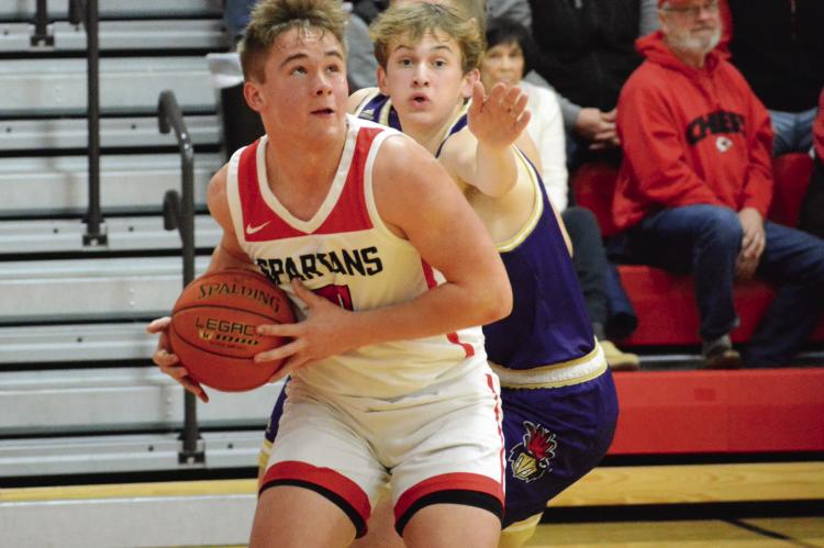 SENIOR THOMAS MURPHY drives the baseline for the Spartans Jan. 6 against visiting Pleasant Hill in varsity boys basketball action. SHAWN RONEY | Staff