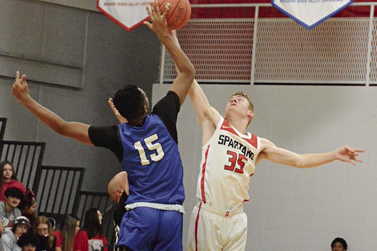 RICHMOND SENIOR Hunter Mitchell (No. 35) and Summit Christian Academy’s Mike Thomas go up for the opening tipoff Dec. 14 at Richmond. SHAWN RONEY | Staff