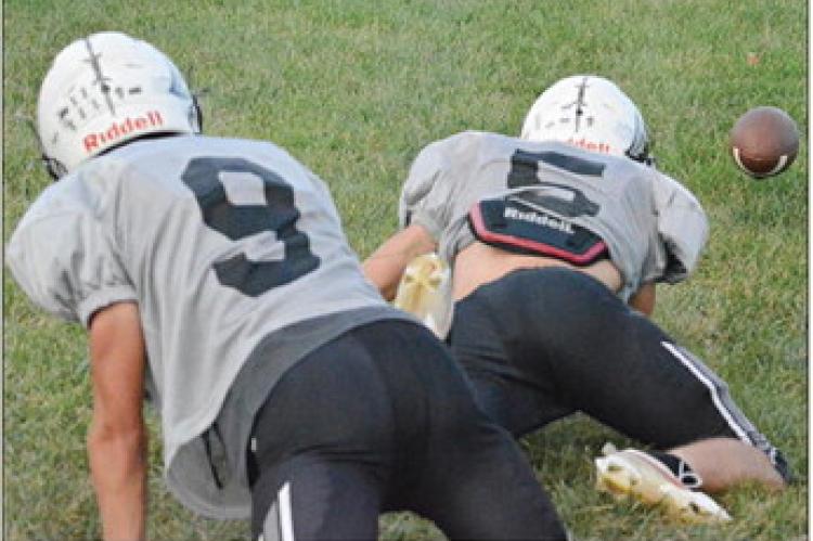 SHAWN RONEY | Staff BRODY FIFER (left) and Drew Hawkins scramble for a loose football as the Aggies practice their tackling Monday at Hardin-Central.