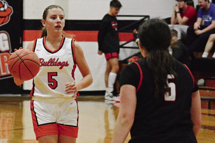 ESTER KINCAID (left) is guarded by Kaitlyn Kellam during Hardin-Central’s season opener with Northland Christian Nov. 17 at Hardin-Central. SHAWN RONEY | Staff