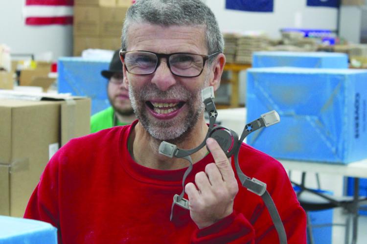 DENNIS MCGOLDRICK, an Ideal Workshop employee, assembles a mask to show open house attendees. See more photos on page 9. SHARON DONAT | Staff